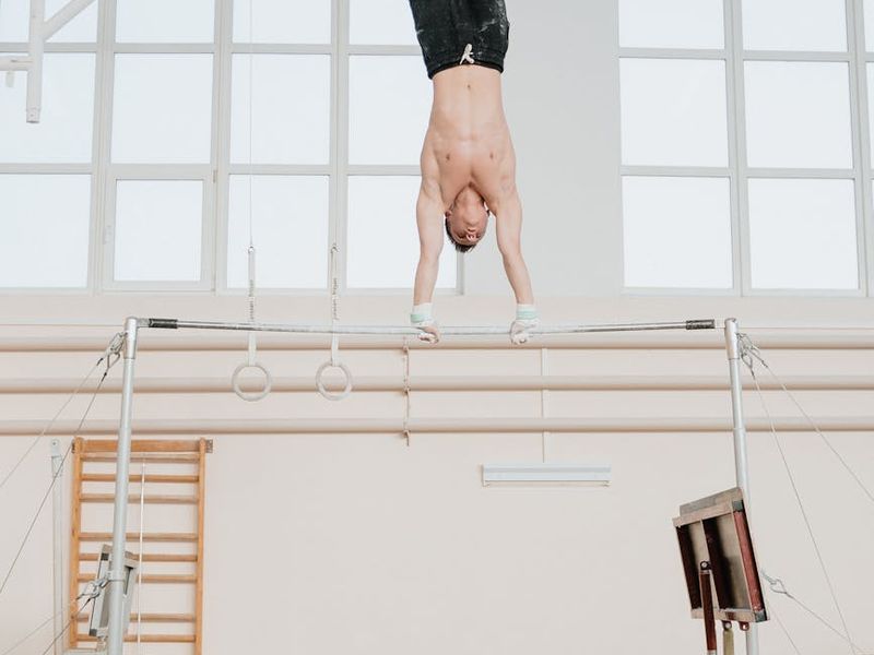 Athletic man performing controlled movements in a gym