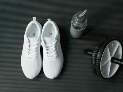 Close up of sports shoes and water bottle on mat